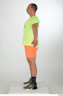 Joel a-pose dressed green sneakers orange shorts sports standing whole…